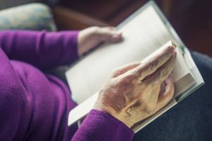 Image of a senior woman reading a book