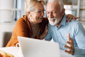 Image of a happy senior couple using a laptop