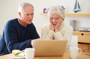 Image of a worried senior couple going over finances