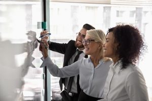 Image of business leaders writing on a whiteboard