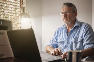 Image of a senior man using his laptop