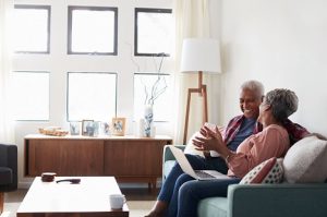 Image of a happy senior couple looking at a laptop