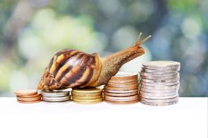 Image of a snail climbing up a pile of change