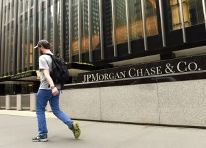 Image of a man walking past the JPMorgan Chase office