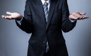 An image of a businessman shrugging