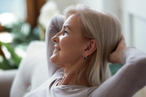 Calm Senior Woman With Hands Behind Head