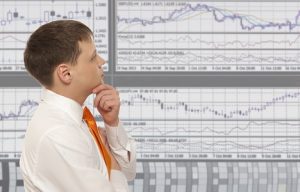 Image of a stock trader looking at monitors