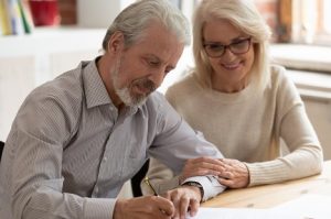 Image of an older couple signing a will