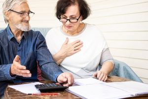 Image of happy mature family calculating bills