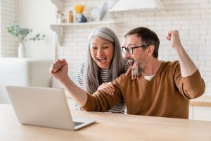 Image of a happy couple viewing their investment win