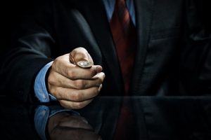 Image of a businessman flipping a coin