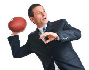 Image of a businessman throwing a football