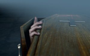 Image of a hand coming out of a coffin