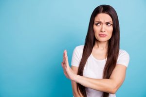 Image of a woman using an open hand to reject something