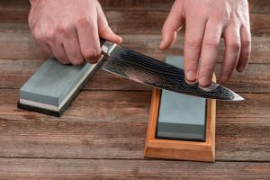 Image of knife getting sharpened on a whetstone, signifying FSK’s dividend cuts