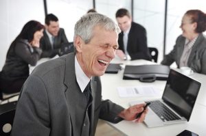 Image of a laughing businessman in management