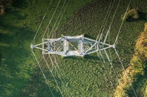 Image of a transmission tower standing on grass