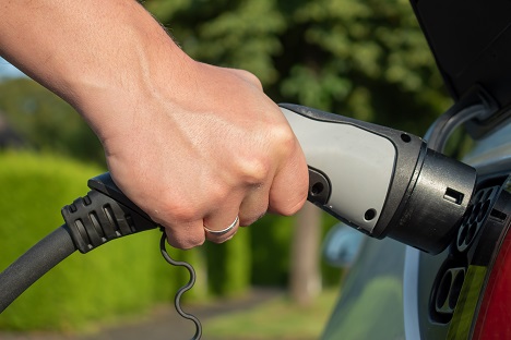 Man Charging Electric Vehicle