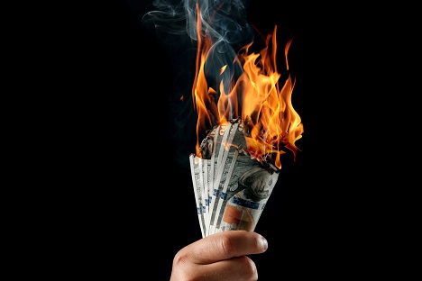 Person Holding Burning Money