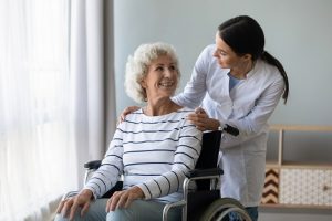 Image of a doctor helping an elderly patient in a wheelchair