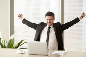 Image of a happy investor with outstretched arms