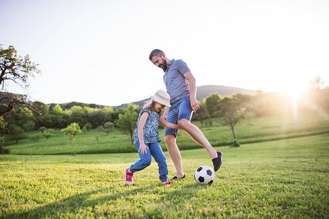 Father and Daughter Playing Soccer