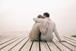 Image of a couple hugging on a pier