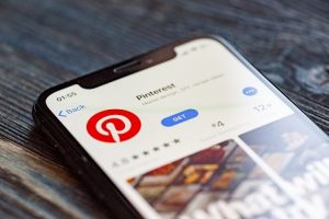 Image of Pinterest app and logo on phone screen