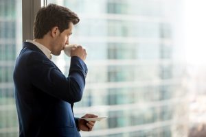 Image of a businessman sipping coffee