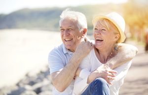 Image of a relaxed elderly couple by the sea