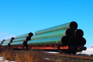 Image of large diameter pipes on railcars