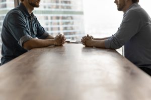 Image of a men sitting opposite