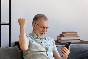 Image of a happy grandfather on the phone