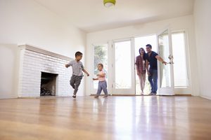 Image of an excited family exploring their new home