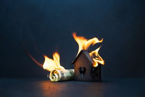 Image of money and a house burning