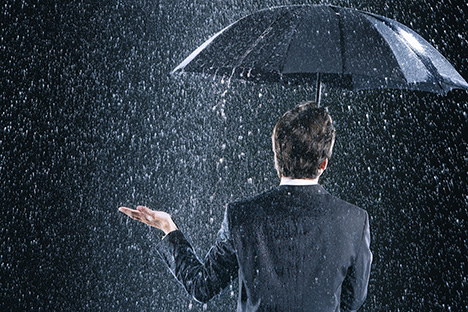 Investor Staying Dry Under an Umbrella