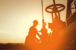 Image of an oil worker and a sunset