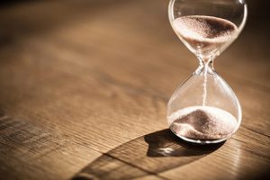 Hourglass running out of sand on desk