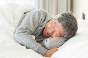 Image of an older investor sleeping blissfully