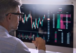 Man in front of stock screen