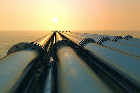 Close-up of pipelines running into sunset