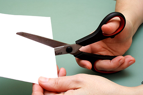 Hand cutting paper with scissors