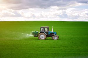 Tractor spraying potash fertilizer