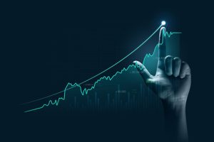 Hand pointing upward on chart to denote success