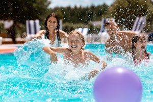 Family playing in the pool