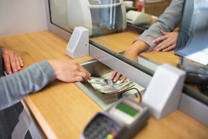 Exchanging money with bank clerk