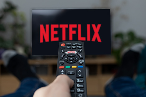 Image of the Netflix logo on TV with remote