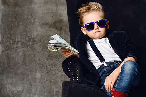 Image of a kid holding cash