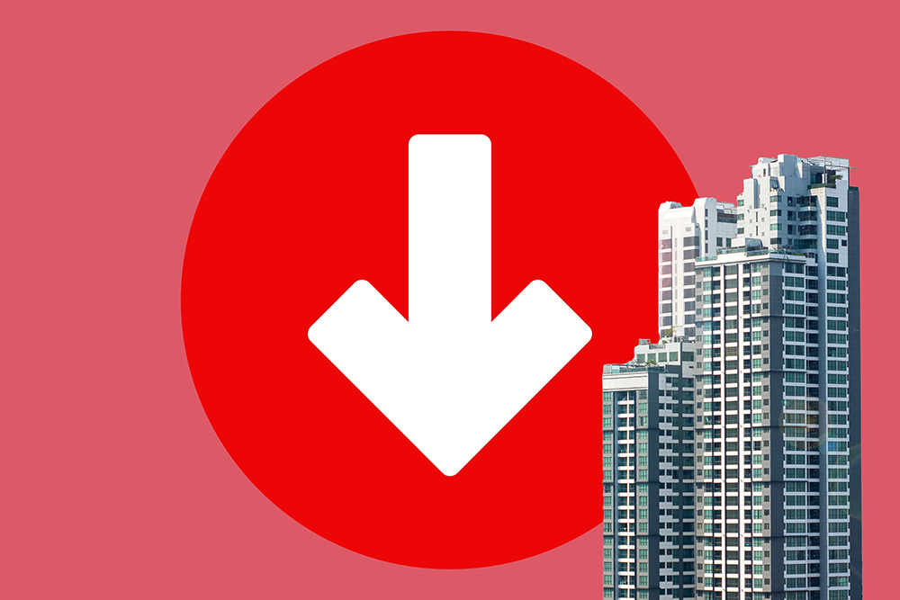 Image of a bright red, downward-facing arrow next to a skyscraper