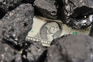 A $1 bill under a few lumps of coal